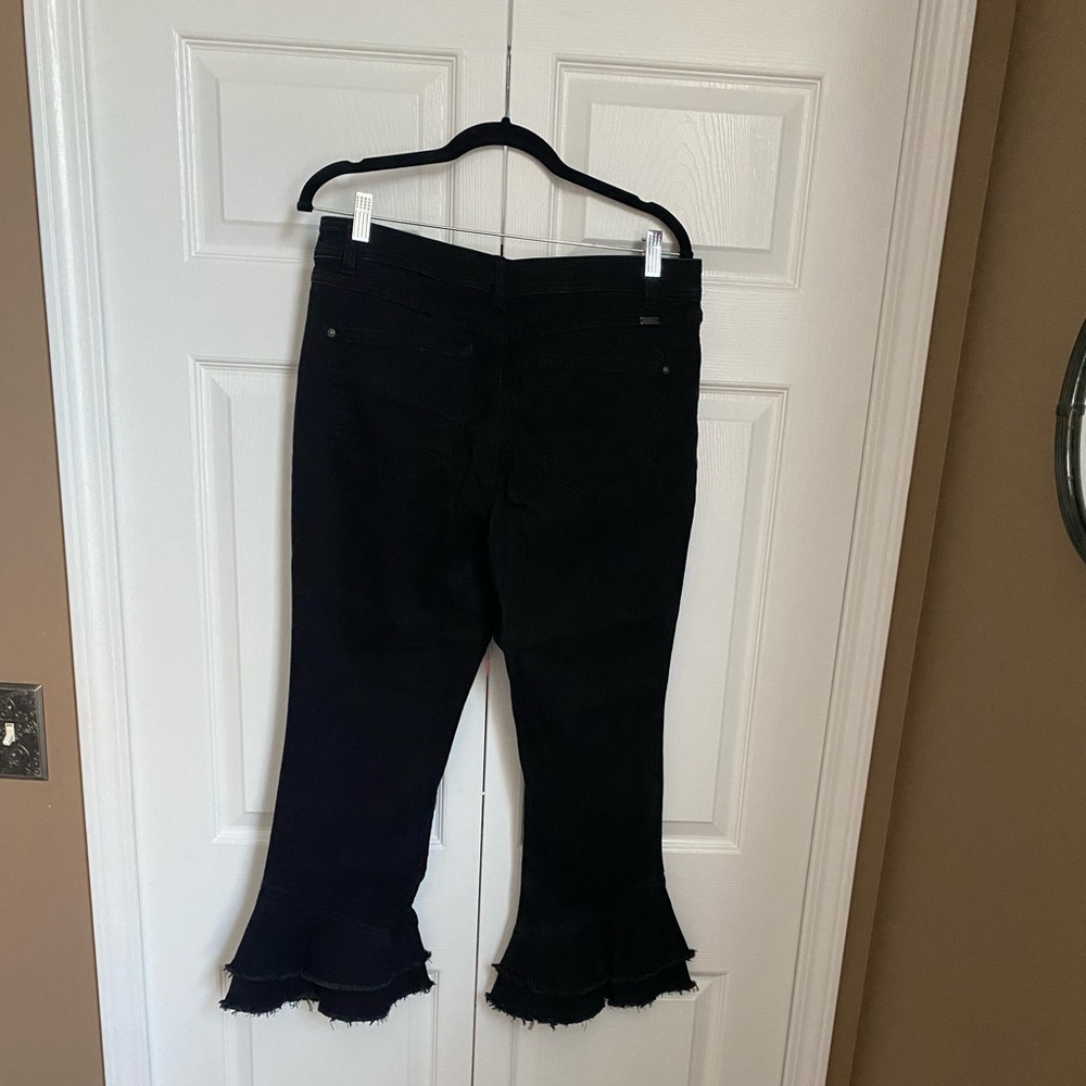 Double ruffles on bottom. INC Black jeans.